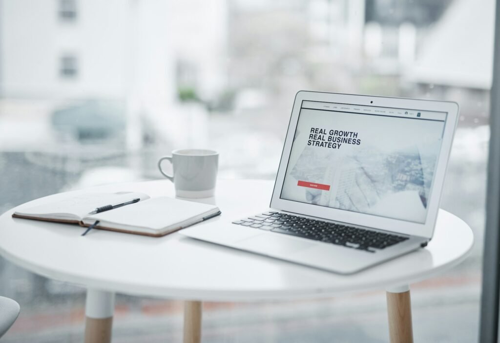 Shot of a laptop displaying a business related website on a table at home